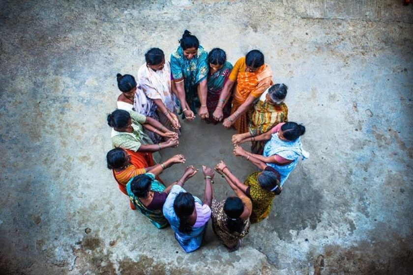 circle-of-people-arms-in-middle-of-circle